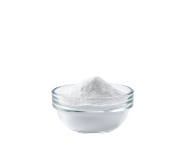 baking soda in a clear glass bowl isolated on white background.