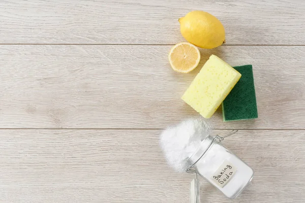 non-toxic cleaner, baking soda and lemon on a white kitchen table, copy space for text.