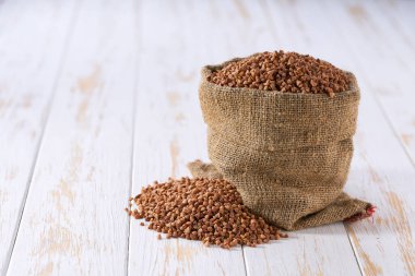 Torbada organik karabuğday. Organik karabuğday torbası. Çuval bezi içinde organik karabuğday ve karabuğday yığını.