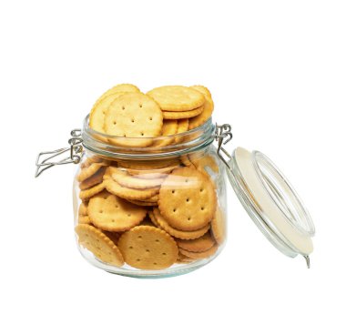 Beyaz arka planda izole edilmiş yuvarlak krakerleri olan açık bir kavanozun yakın plan görüntüsü.