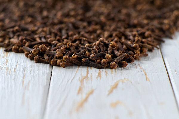 cloves spice on a light kitchen table, selective focus.