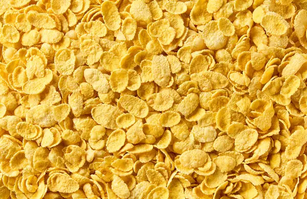 Mısır gevreği arka plan ve doku, yakın plan. Üst Manzara. Taze ve sağlıklı kahvaltı konsepti. Lezzetli altın mısır gevrekleri.