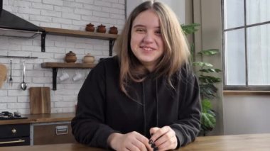 Happy european teenage student looking at webcam, making video call to distant friend or teaching online, female teacher teacher smiling, vlog talking to webcam 4K