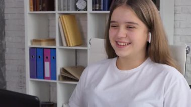 Girl, student wear headphones learn watching online webinar webcast class looking at laptop elearning distance course or video calling teacher by webcam. 4K