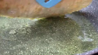 Pasties cheburek with meat fried in sunflower oil, deep fry. Crimean Tatar fast food, traditional food. Dough in a pan with hot oil.