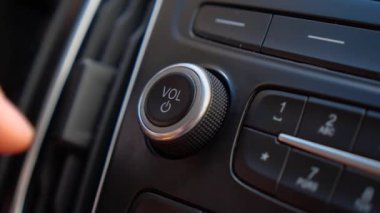 Sürücü arabadaki radyonun sesini ayarlar.