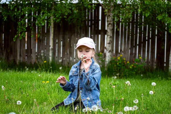 緑の芝生の上に帽子をかぶった白いドレスの少女 — ストック写真