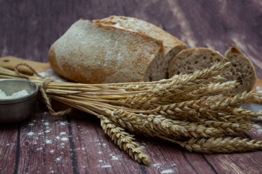 bread and spikelets on an old background.