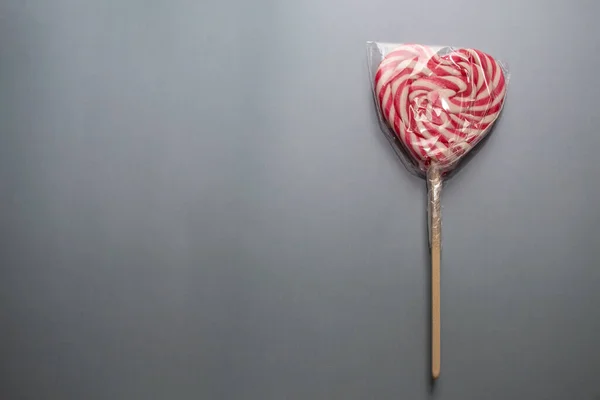 a lollipop heart shaped lollipop on a stick