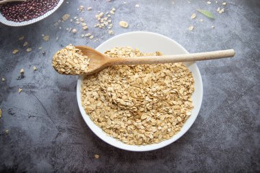 Arka planda yulaf ezmesi olan bir kase.