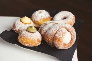 Bir sürü taze kruvasan, çikolata, fıstık, ahşap masa içi krema, yakın plan. Fransız pastası..