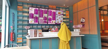 The buyer making payment transaction food at cashier. Inside of interior Solaria restaurant. Fast food local restaurant. Jakarta, Indonesia - December 26 2024 clipart