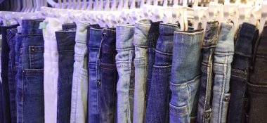 Pasar Senen 'de satılık bir askıda asılı duran kot pantolonun değişik çeşitleri. Jakarta, Endonezya