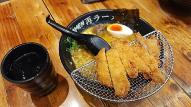 Sai Ramen Lokantası 'nda siyah bir kase körili tavuk katsu ramen eriştesi. Jakarta, Endonezya - 12 Mayıs 2025
