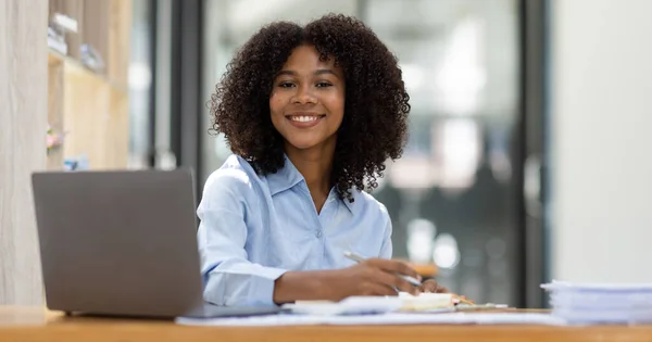 stock image Successful african american accountant business woman work documents tax on laptop computer in office. finance investment economy and marketing research concept.