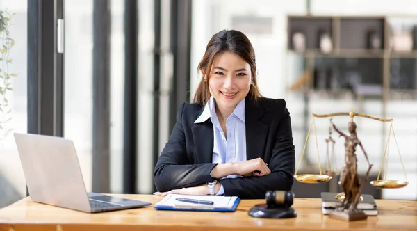 Business Asian woman in suit and Lawyer working on a documents at workplace office. Judge gavel with Justice lawyers,  Legal law, advice  and justice concept