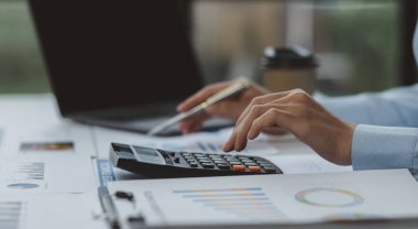 Businessman working at office with documents on his desk, doing planning analyzing the financial report, business plan investment, finance analysis concept	