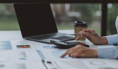 Businessman working at office with documents on his desk, doing planning analyzing the financial report, business plan investment, finance analysis concept	
