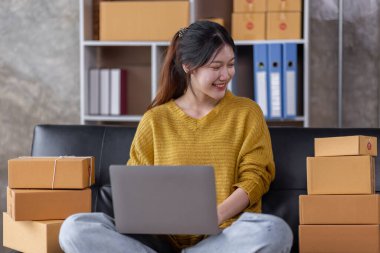 Portrait of Online business owner Asian female small businesses SME entrepreneur working at home, online marketing, packing boxes, SME sellers, concept, e-commerce team, online sales.
