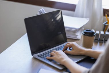 Asian businesswoman Accounting using calculating income-expenditure and analyzing real estate investment data report Financial and tax systems in workplace an home office.