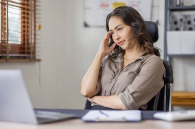 Asian indian women are stressed while working on laptop, Tired asian businesswoman with headache at office, feeling sick at work copy space in workplace an home office.