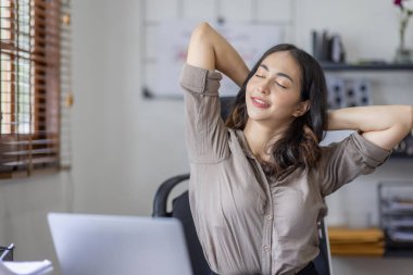 Asian indian women are stressed while working on laptop, Tired asian businesswoman with headache at office, feeling sick at work copy space in workplace an home office.