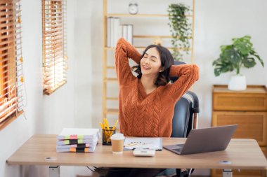 Freelancer Asian businesswoman Accounting work at home using calculating income-expenditure and analyzing real estate investment data report Financial and Documents tax systems concept.