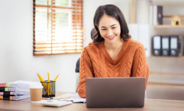 Freelancer Asian businesswoman Accounting work at home using calculating income-expenditure and analyzing real estate investment data report Financial and Documents tax systems concept.