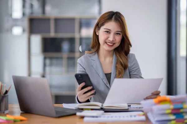 Smiling Young Asian Business Woman Executive Looking Smartphone Using Cellphone 스톡 사진