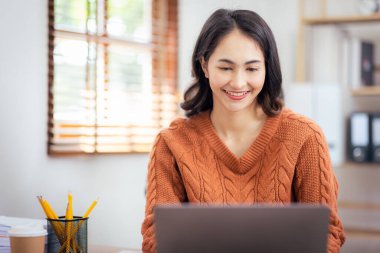 Freelancer Asian businesswoman Accounting work at home using calculating income-expenditure and analyzing real estate investment data report Financial and Documents tax systems concept.