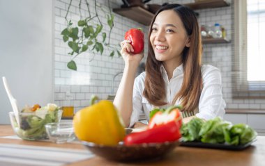 Portrait of attractive asian japanese woman in kitchen at home, young girl browsing website on tutor cooking class and doing for kitchen, cutting vegetables, cooking, cooking concept.