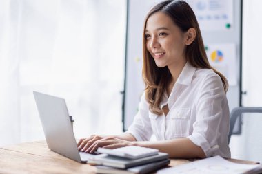 Business woman using calculator for do math finance on desk in Home office, Asian female finance business tax, accounting, statistics and analytic research concept