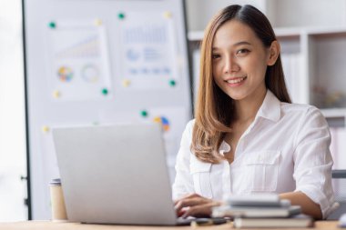 Business woman using calculator for do math finance on desk in Home office, Asian female finance business tax, accounting, statistics and analytic research concept