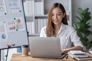 Business woman using calculator for do math finance on desk in Home office, Asian female finance business tax, accounting, statistics and analytic research concept