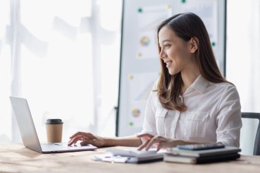 Business woman using calculator for do math finance on desk in Home office, Asian female finance business tax, accounting, statistics and analytic research concept