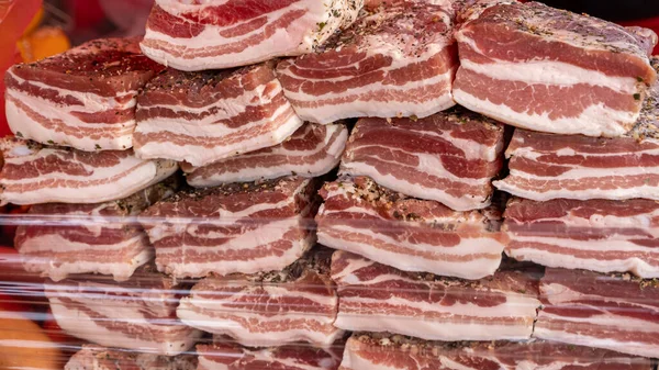 stock image Large pieces of salted bacon. According to traditional Ukrainian recipes. Handmade trade in the rural market