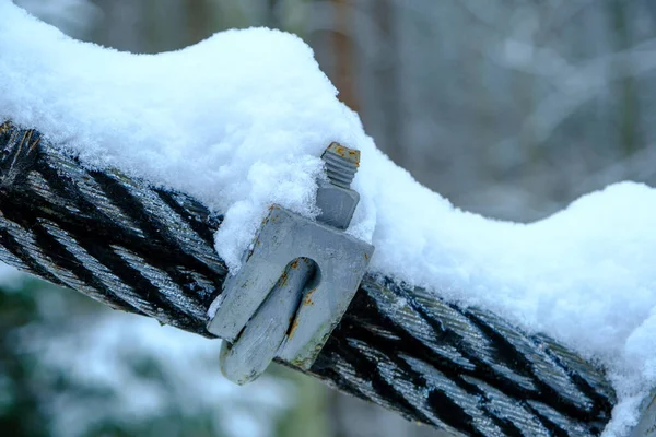 stock image The cable ties of the pedestrian bridge are screwed together with screws. snowy winter