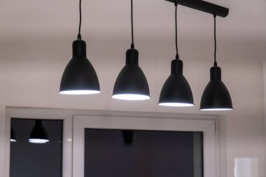 Kitchen light elements, lamps. Black dome lamps. Bright renovated kitchen space. Ceiling Light LED Round Surface.