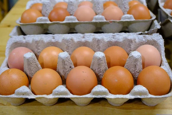 Fresh brown farm eggs in a package, Home Producers Market.