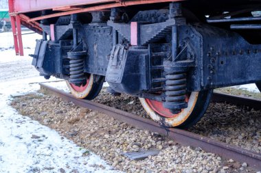 Old steam locomotive wheel and connecting rods. Tie rod or side rod for drive wheels. A retro specimen.