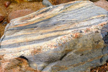 Beautiful colorful texture stone background. The coast of the Baltic Sea in Latvia.