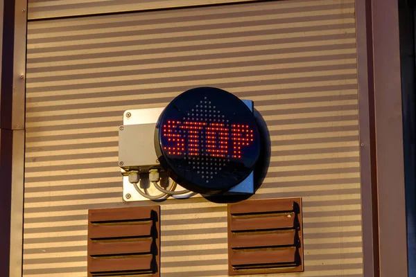 Red LED light inscription with warning. stop.