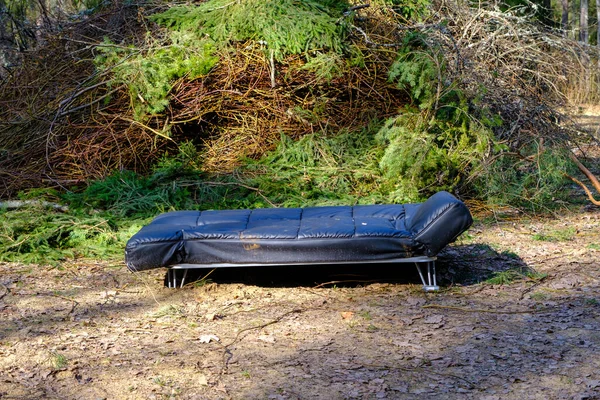 stock image Garbage in the meadow next to the forest. People illegally throw garbage in the forest. Illegal garbage dump in nature. Dirty environment polluting waste in the forest.