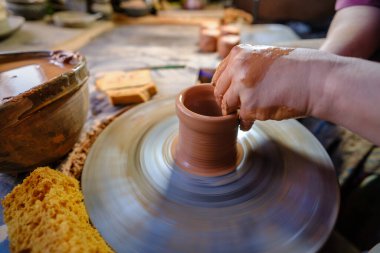 seramik, atölye, seramik sanat konsepti - yeni bir kap oluşturan insanın ellerinin yakın çekimi, insanın parmakları çömlekçi çarkı ve ham kenar, ön yakın plan