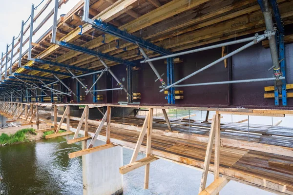 stock image Construction of a bridge over the river Gauja in Latvia. Construction of wooden structures for concreting the bridge. Gauja is the longest river in Latvia.