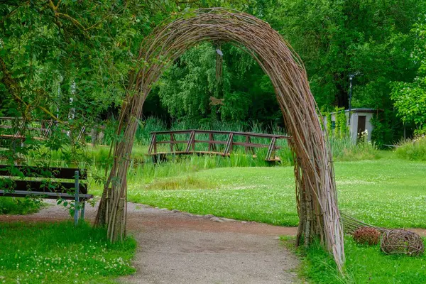 Beautiful park environment. A wooden bridge and an arch made of branches. a beautiful place for rest and recovery. relax