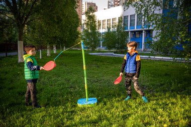 İki arkadaş yaz kampında tetherball swing oyunu oynuyorlar. İki erkek kardeş açık havada sağlıklı vakit geçirmekten mutlu..