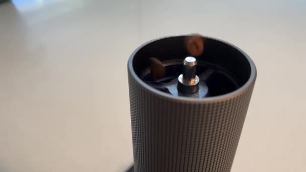 咖啡豆被倒入现代金属咖啡研磨机中 在白色桌子上展示所有细节的特写镜头一个刻度的咖啡豆研磨机衡量了手工咖啡的谷物数量 — 图库视频影像
