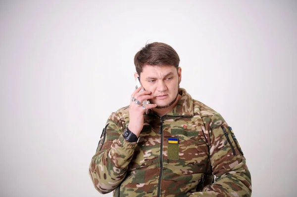 Soldier Mobile Phone, Military Man Camouflage Army Uniform calling serious conversation military man talking wrinkled forehead important message data transmission war Russia aggressor in Ukraine