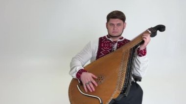 Yakışıklı orta yaşlı bir adam Ukrayna 'nın bağımsızlığının ve Ukrayna' nın yenilmezlik zaferinin müzik enstrümanını çalıyor. Nakış sanatındaki kahraman müzisyenlere zafer kazandırıyor.